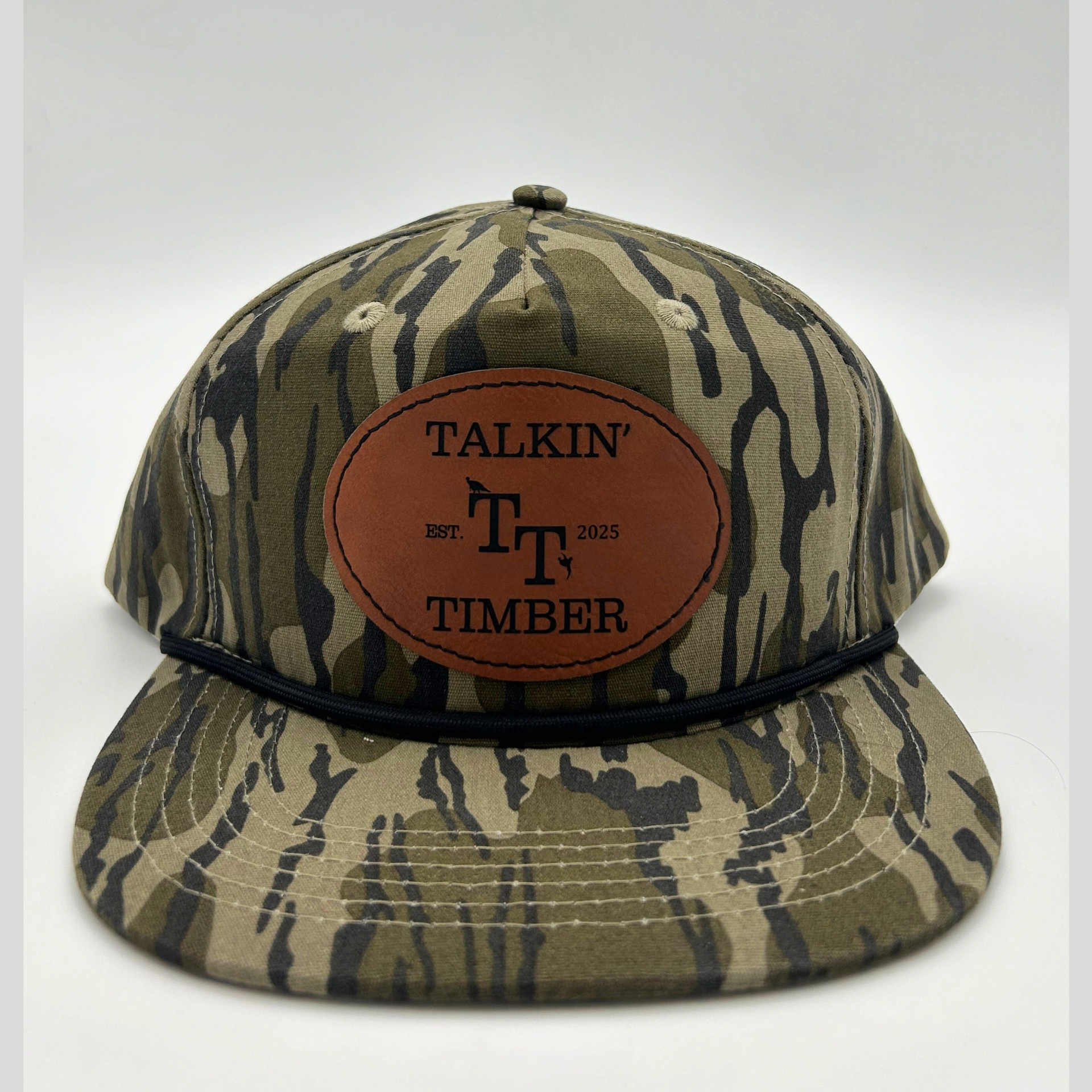 Front view of Mossy Oak Bottomland™ rope hat with genuine leather patch, adjustable fit, and vintage camo pattern for hunting enthusiasts.