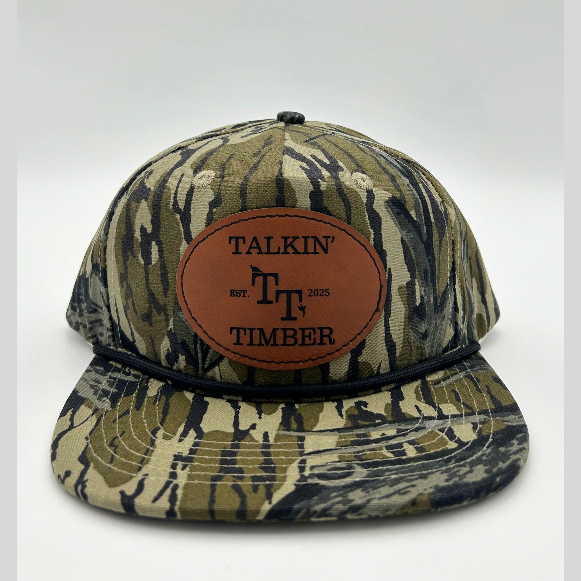Front view of Mossy Oak Treestand™ rope hat with genuine leather patch and camouflage design, ideal for duck, turkey, and deer hunters.