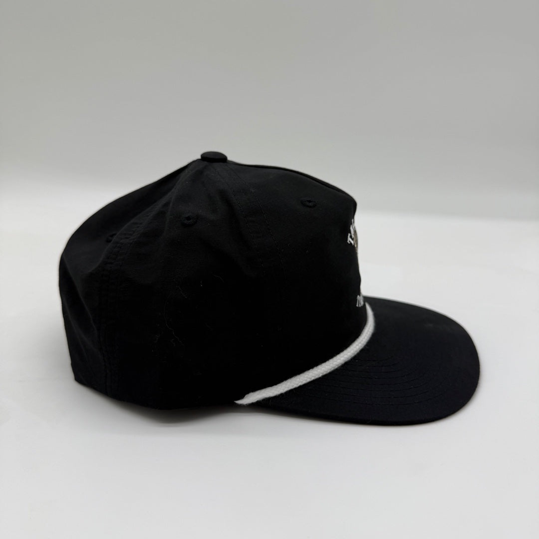 Side view of the Talkin’ Timber Black Buck Hat showing the black crown, flat bill, and contrasting white rope.
