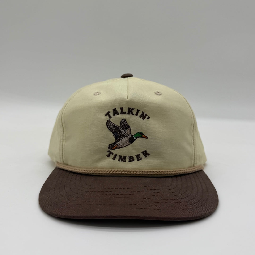 Front view of the Talkin’ Timber Cream Mallard Hat with a cream crown, brown bill, tan rope, and flying mallard embroidery.