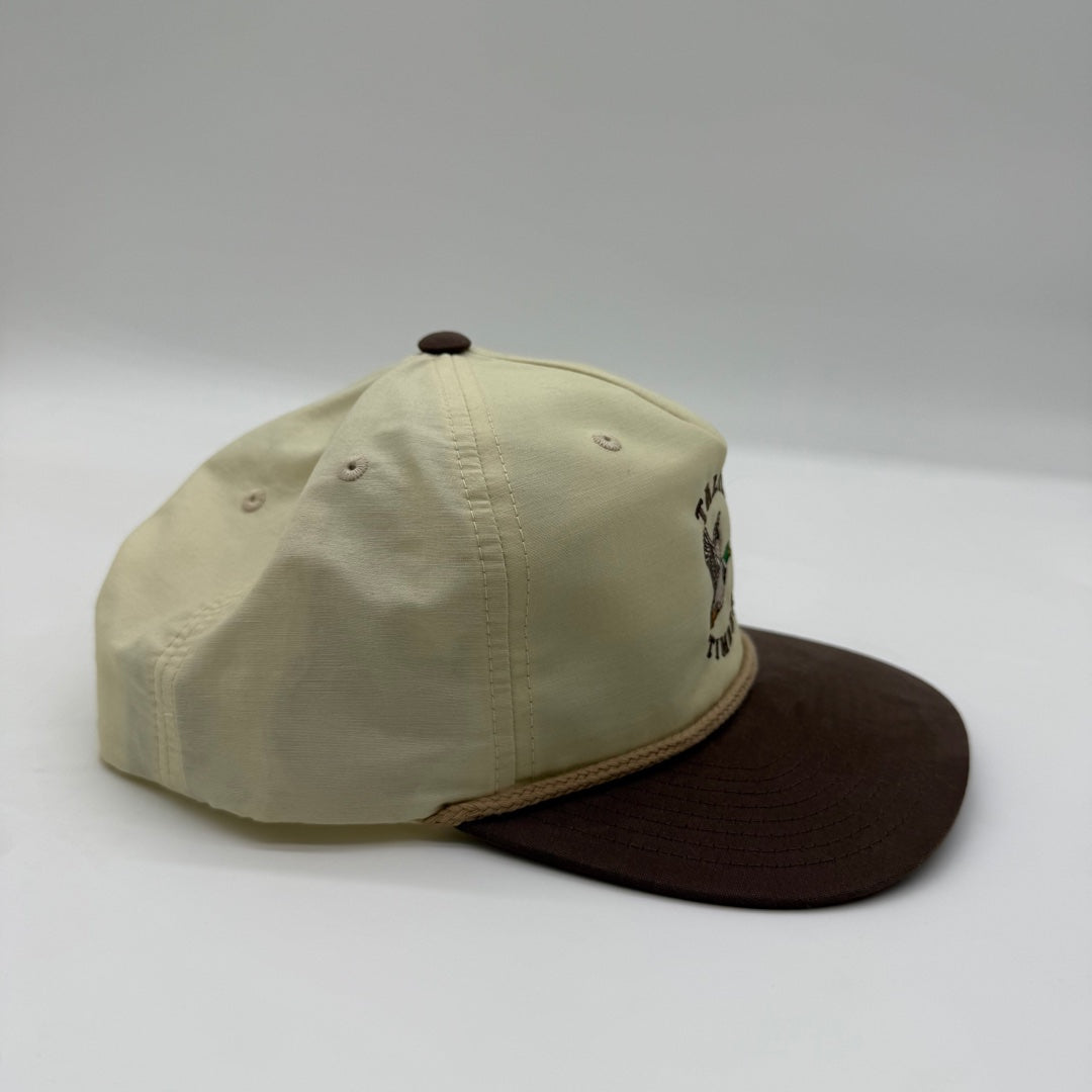 Side view of the Talkin’ Timber Cream Mallard Hat showing the cream crown, brown flat bill, and tan rope detail.