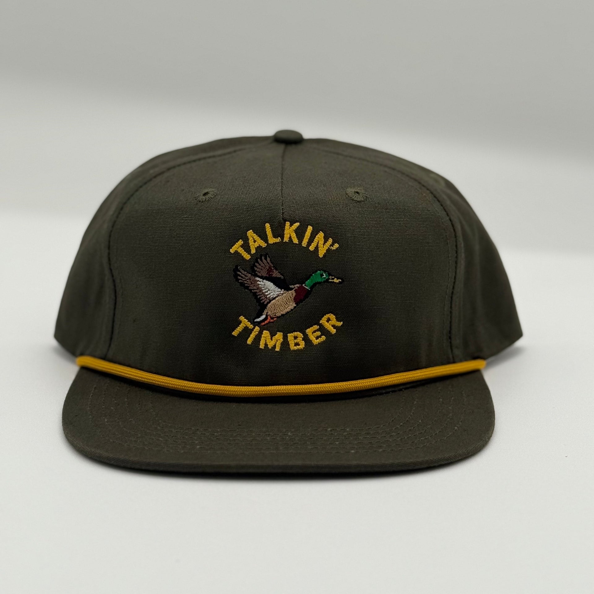 Dark green cap with 'Talkin Timber' logo on a light gray background