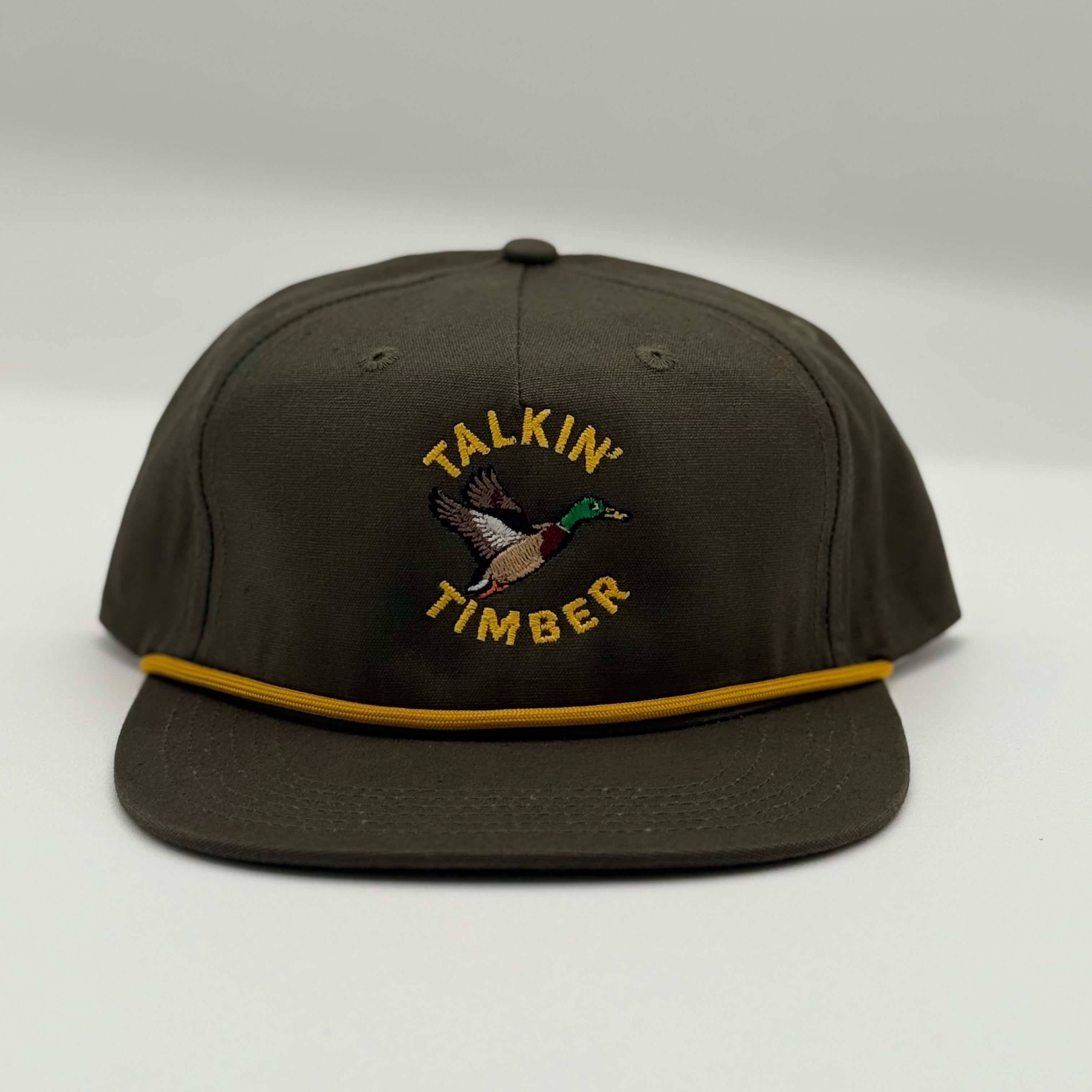 Dark green cap with 'Talkin Timber' logo on a light gray background