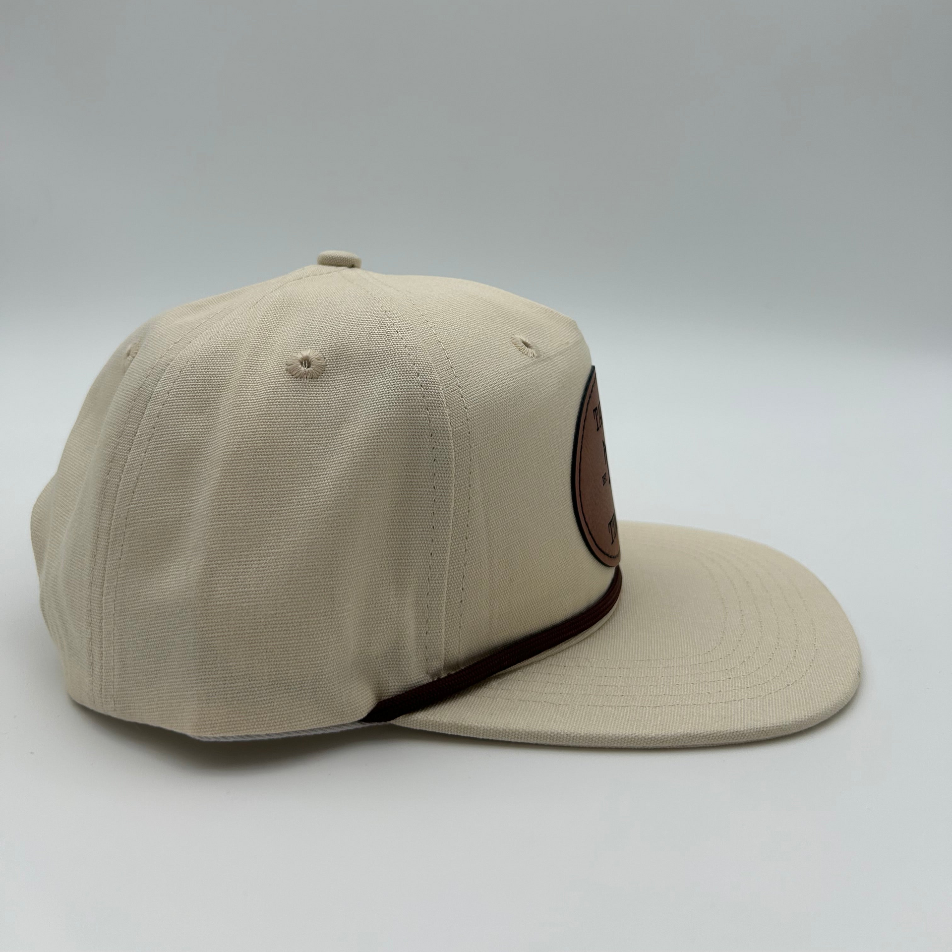 Side view of Casual cream rope hat with minimalist design and genuine leather patch, perfect for everyday wear. Golf, going out to eat, or on a date. 
