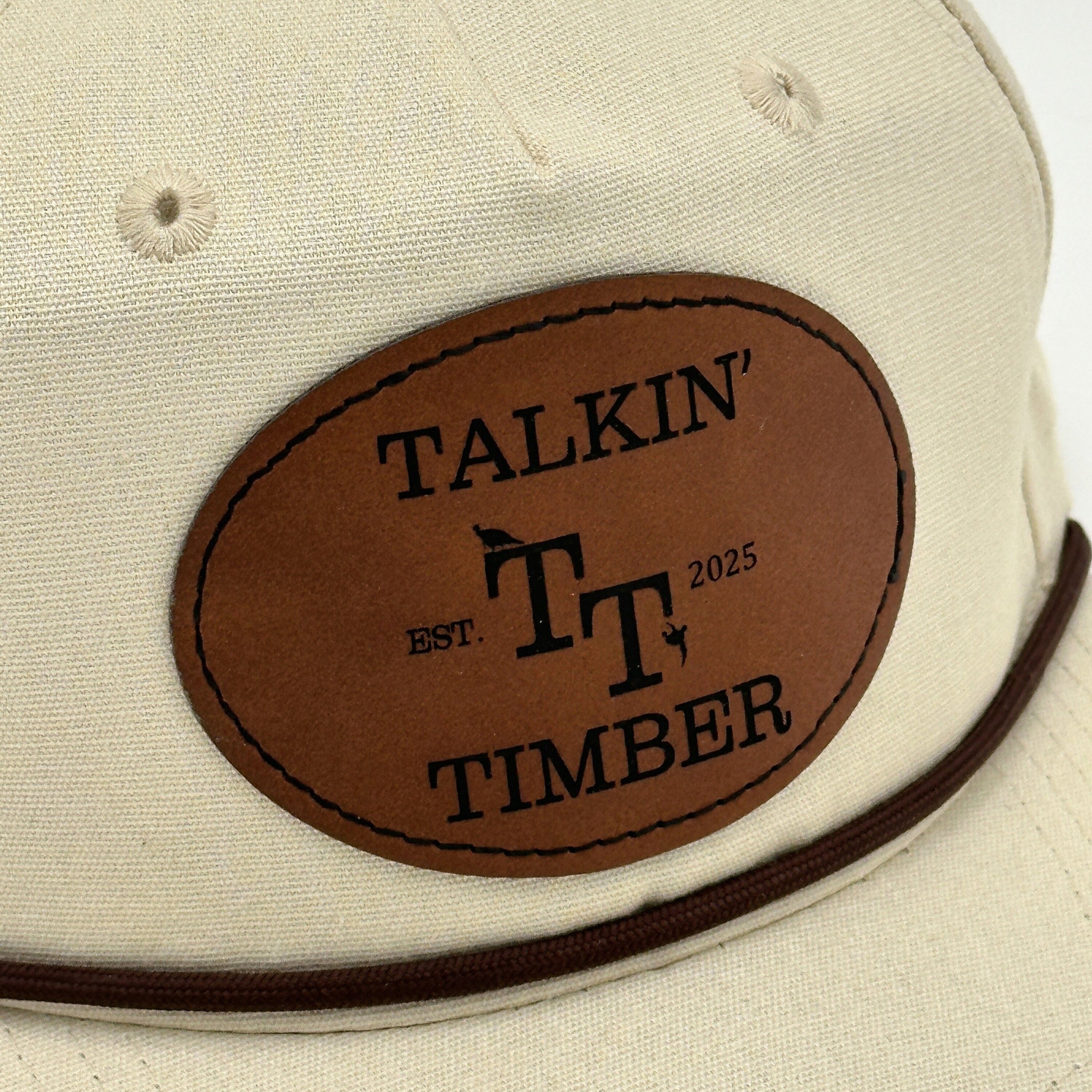Close up patch view of Casual cream rope hat with minimalist design and genuine leather patch, perfect for everyday wear. Golf, going out to eat, or on a date. 